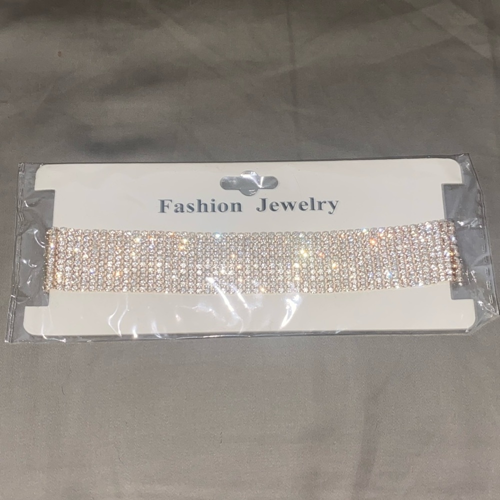 Costume jewelry gold colored rhinestone choker with body chain